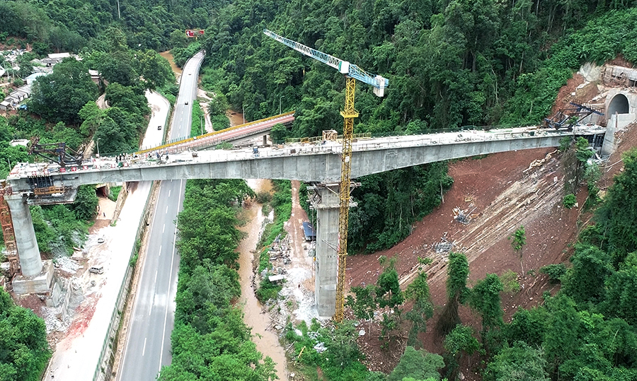 南大窩河大橋地處兩座隧道間的南木窩河山谷之上，全長179米，最大墩高39米，先后跨重要公路及河流，施工地貌和自然環境特殊。項目部采取各種措施，保證了道路行車和施工安全兩不誤。圖為南大窩河大橋合龍。（胡子豪 攝）