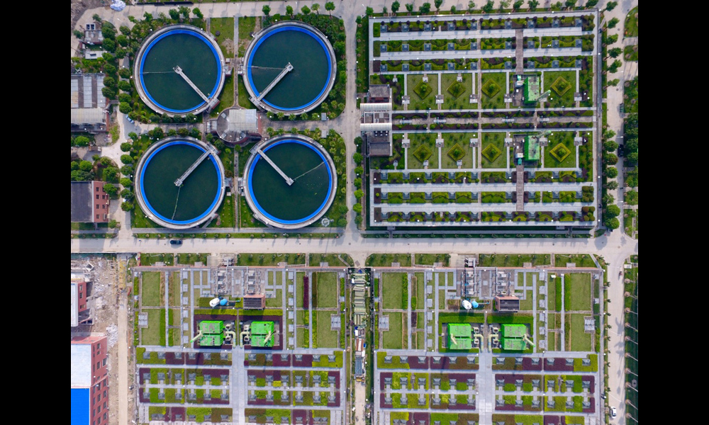 洋里污水廠位于福州鼓山南麓，擔(dān)負著76平方公里、150萬人口的污水處理任務(wù)，日處理污水60萬噸。圖為7月2日，無人機拍攝的福州洋里污水廠三期二次沉淀池和頂層綠化的生物反應(yīng)池。（新華社記者 姜克紅 攝）