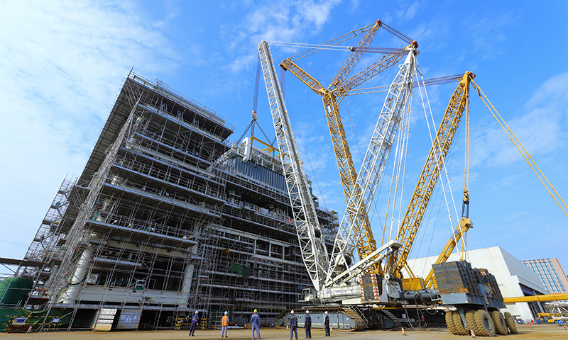 該電氣間吊裝重量約480噸，由一臺(tái)1250噸履帶吊和一臺(tái)2000噸履帶吊配合吊裝完成。圖為Mini E-House（電氣間）吊裝現(xiàn)場(chǎng)。