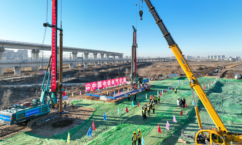 雄忻高鐵是我國(guó)“八縱八橫”高速鐵路網(wǎng)京昆通道的重要組成部分，線路東起京雄城際鐵路雄安站，西至大西高鐵忻州西站，正線全長(zhǎng)342公里，設(shè)計(jì)時(shí)速350公里。圖為2月25日，中鐵電氣化局的施工人員在雄忻高鐵新蓋房特大橋建設(shè)現(xiàn)場(chǎng)施工（無人機(jī)照片）。新華社記者 牟宇 攝