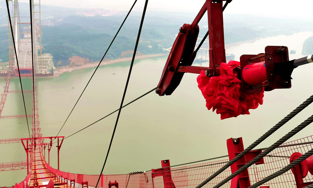 針對這種全新的橋型，項(xiàng)目團(tuán)隊(duì)提出“單側(cè)同步、南北異步、體系同步”的指導(dǎo)性施工原則，制定斜拉段和懸吊段同步架設(shè)安裝的總體施工工序，主纜采用預(yù)制平行索股法進(jìn)行架設(shè)，即預(yù)先將若干鋼絲組合成正六邊形截面的平行鋼絲束，用纖維強(qiáng)力帶包扎成平行鋼絲索股，兩端安裝錨頭，利用雙線往復(fù)式牽引系統(tǒng)架設(shè)索股，全部索股架設(shè)完成后，利用緊纜機(jī)將所有索股形成一根主纜，成為大橋的主要承重結(jié)構(gòu)。