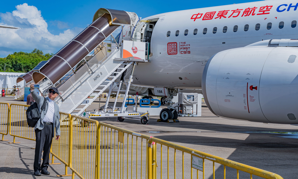 在為期6天的新加坡航展中，中國東航每個專業觀眾日接待團體觀眾超過20批。其中登機參觀者還有來自飛機制造商、航空服務提供商以及航空產業鏈上下游企業的負責人和資深專業人士。圖為參觀者與C919合影。