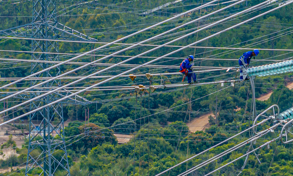 500千伏汕尾甲湖灣電廠機組擴建接入系統工程組塔架線施工現場。