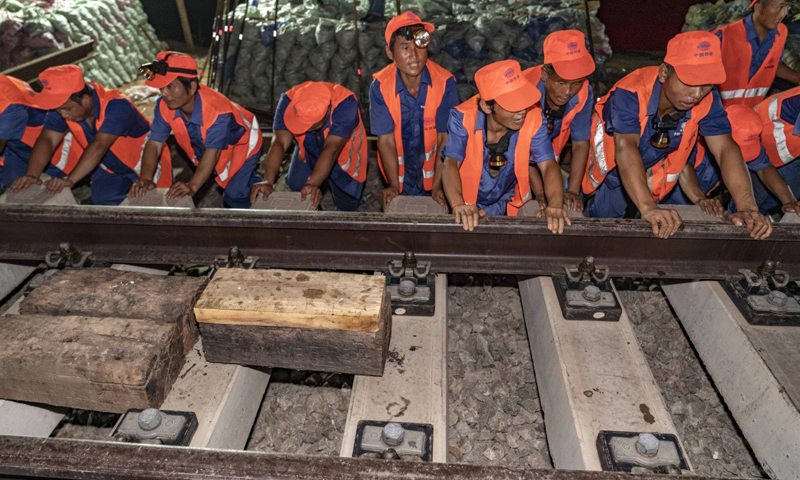 昌贛高鐵全長415.734公里，北起江西南昌，南至贛州，設計時速350公里。這條高鐵建成通車后，井岡山革命老區(qū)、贛南等原中央蘇區(qū)將正式邁入高鐵時代。圖為7月19日凌晨，中鐵十一局三公司職工在推入道岔。（新華社記者 杜華舉 攝）